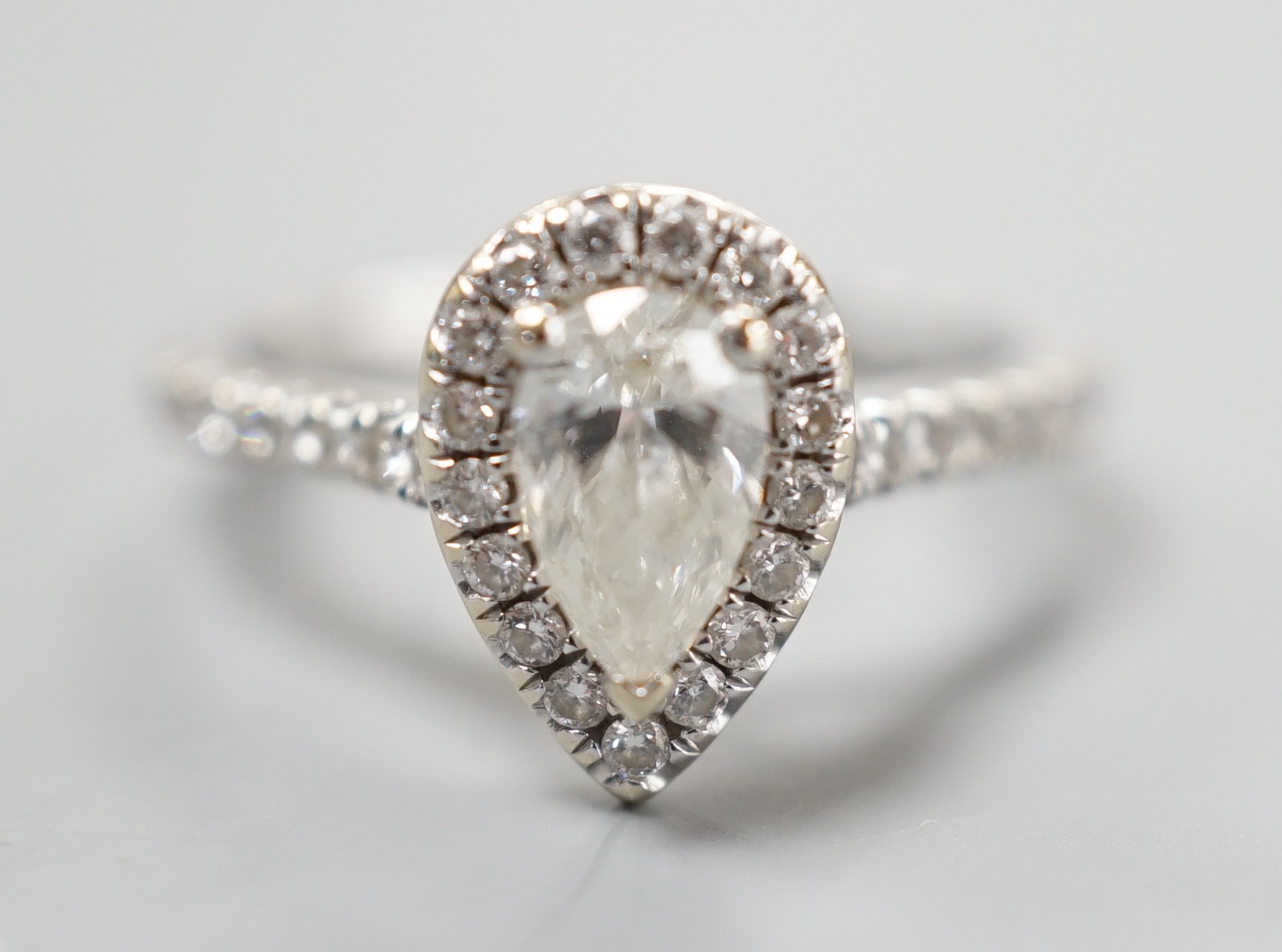 A modern '77 Diamonds' 18ct white gold and singe stone pear cut diamond set ring bordered with brilliants, with GIA report date 29/12/2016 stating the single stone to weigh 0.50ct with a colour and clarity of I and VS1,